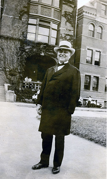black and white photo of a smiling D.B. Johnson in front of Tillman Hall