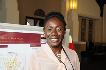 a 2012-2013 McNair scholar presents her research during a poster session
