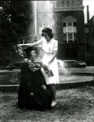 black and white photo of the daisy chain tradition with the fountain in the background