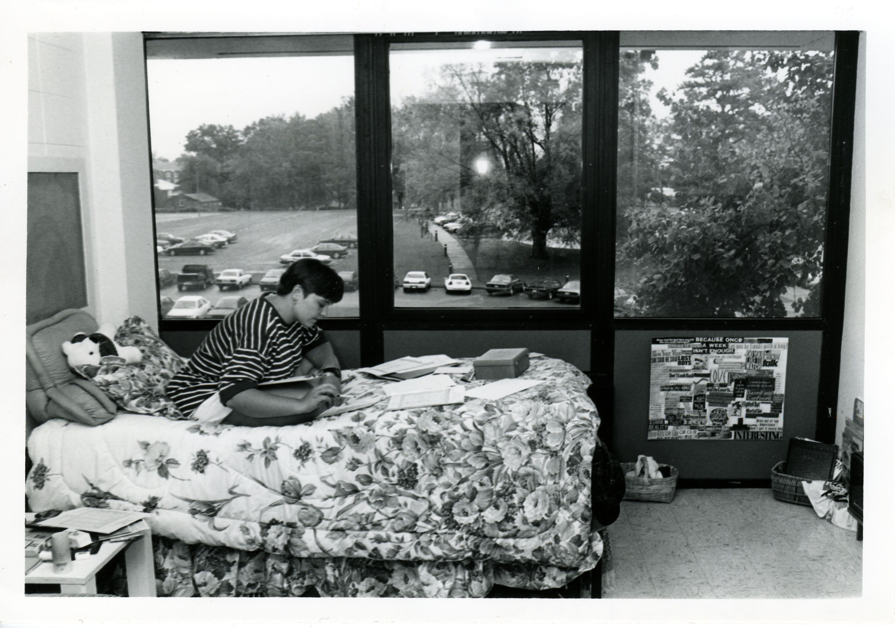 Women reading a book on a bed with a window in the background
