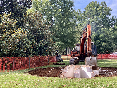 another angle of the excavator during the demolition of the fountain