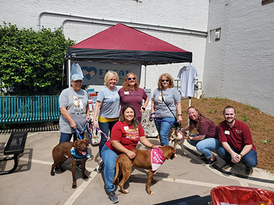 A group photo of Rock Hill Alumni with dogs