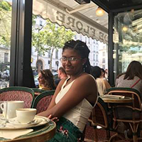 A student sitting in a cafe in Paris