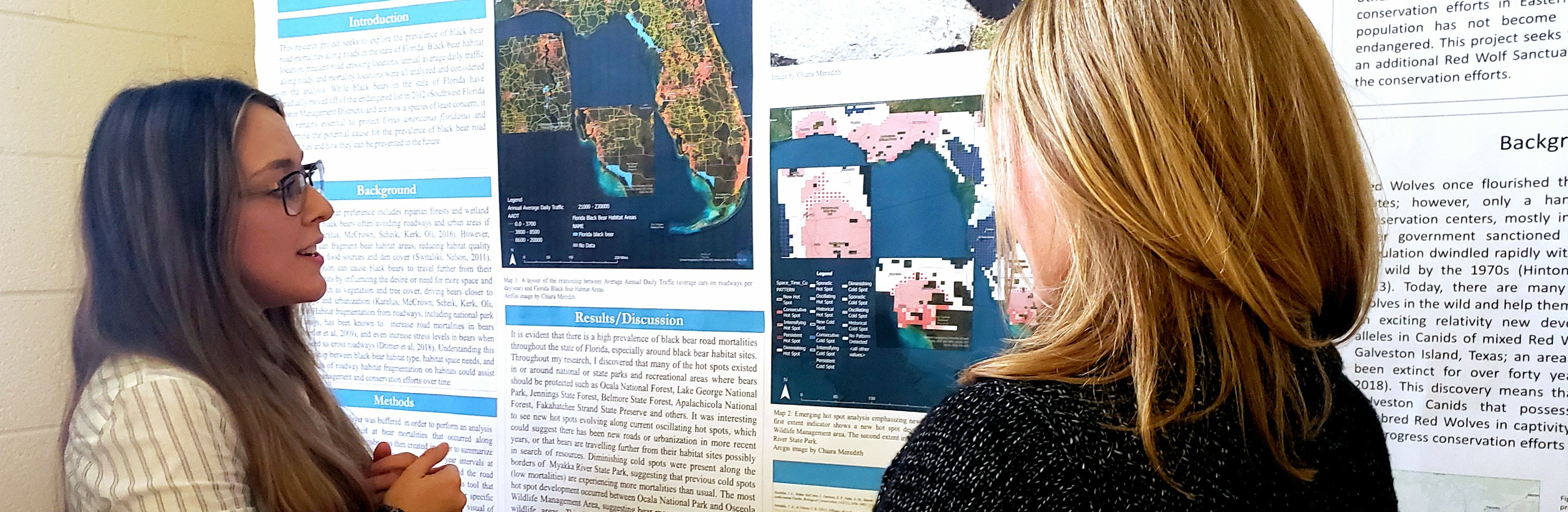 Student presenting a GIS poster
