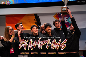 Winthrop League of Legends players holding a trophy on stage overlaid with text that
                        reads HUE Fest League of Legends 2023 Champions. Denathor, Trixter, Sword, Mobility,
                        Chookies.