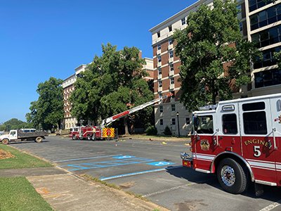 Fire department trucks with crane in front of high rise residence hall